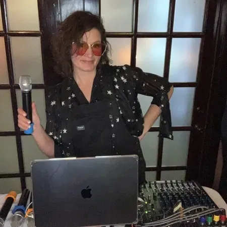 An Expressway Music karaoke DJ at the booth with laptop, mixer, and wireless mic
