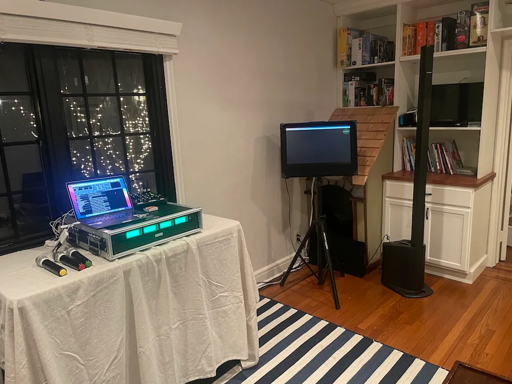 Karaoke rental rig set up in an NYC living room with TV monitor and speaker